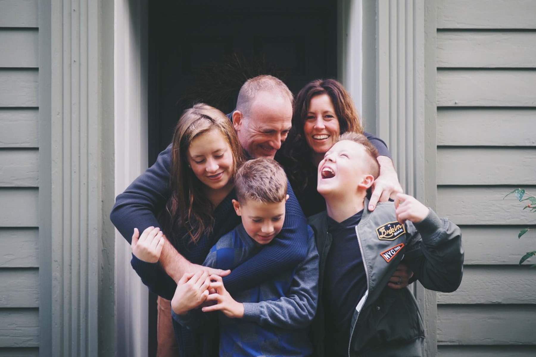 Family celebrating outside of newly purchased home